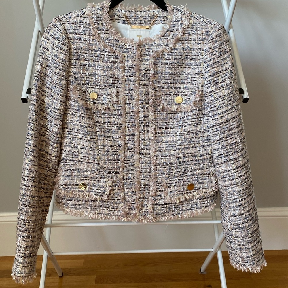 A cropped boucle jacket with fray detail.